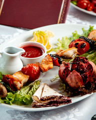 fried chicken and vegetables on stick and ketchup