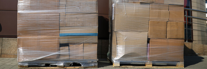 Huge pile of cardboard boxes packed together with stretch tape