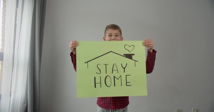 coronavirus quarantined boy holds a sign stay home save lives