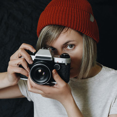 Young woman with analog camera