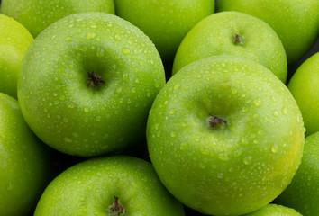 Fresh green apples with water drops