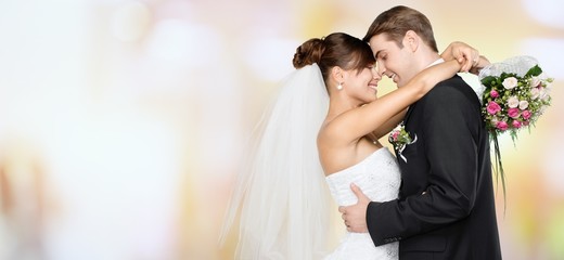 Happy just married young couple on blur background