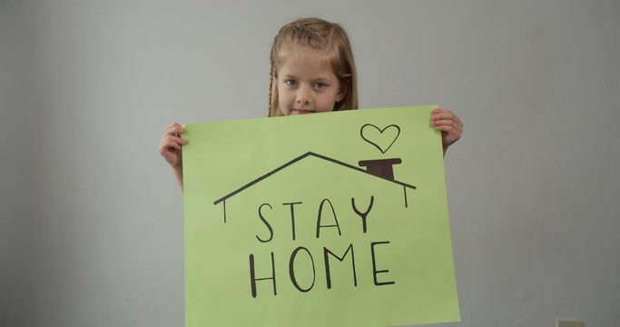 coronavirus quarantined girl holds a sign stay home save lives