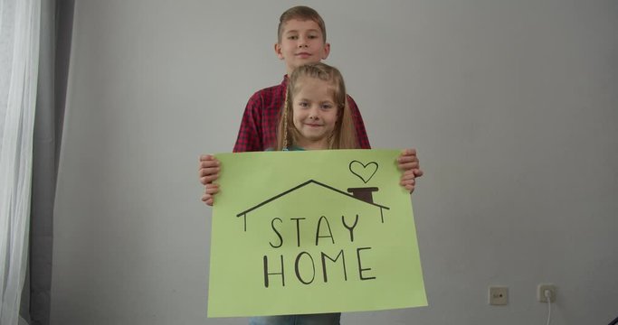 coronavirus quarantined boy and girl holds a sign stay home save lives