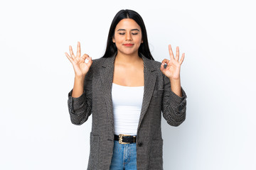 Young latin woman woman isolated on white background in zen pose