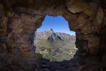 inside a cave looking at table mountain