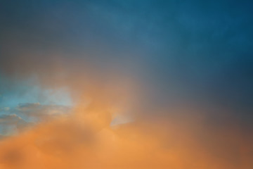 The sky at sunset. Cumulus clouds lit by the rays of the setting sun.