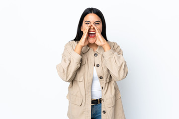 Young latin woman woman isolated on white background shouting and announcing something