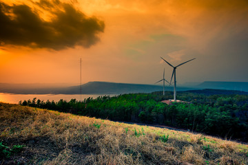 Obraz premium Natural blurred natural background, high angle viewpoint area, overlooking trees and mountains and large windmills,abundance of forests