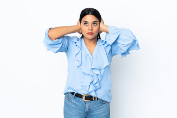 Fototapeta premium Young latin woman woman isolated on white background frustrated and covering ears