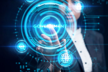 Business, Technology, Internet and network concept. Young businessman working on a virtual screen of the future and sees the inscription: Government