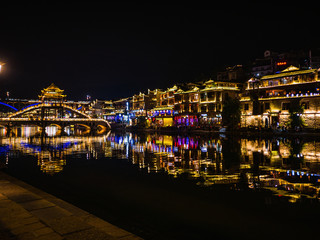 fenghuang,Hunan/China-16 October 2018:Tourist walking with beautiful Scenery view in the night of fenghuang old town .phoenix ancient town or Fenghuang County is a county of Hunan Province, China