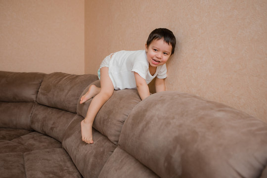 Toddler Boy Brunette Plays At Home on the Couch