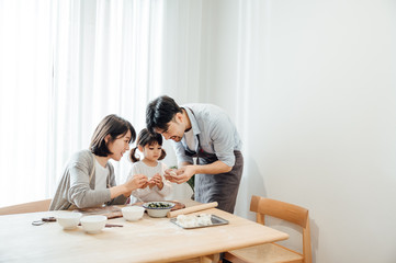 Mom and Dad and daughter at home dumplings