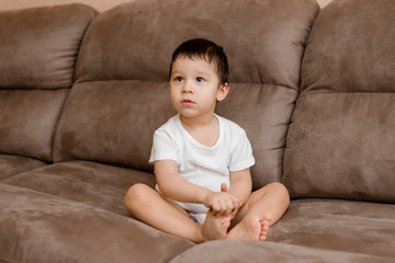 Toddler Boy Brunette Plays At Home on the Couch