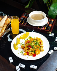 fried potato with vegetables and orange juice