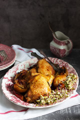 Baked chicken with apples, served with sprouted seeds and sauce.