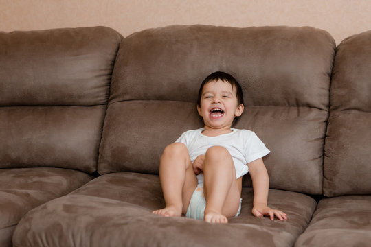 Toddler Boy Brunette Plays At Home on the Couch
