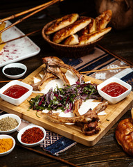 fried ribs with side sliced herbs and onion