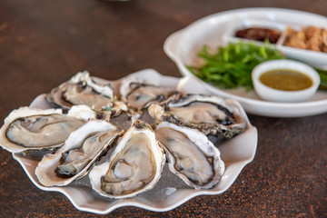 Fresh oysters in a lid on a white plate