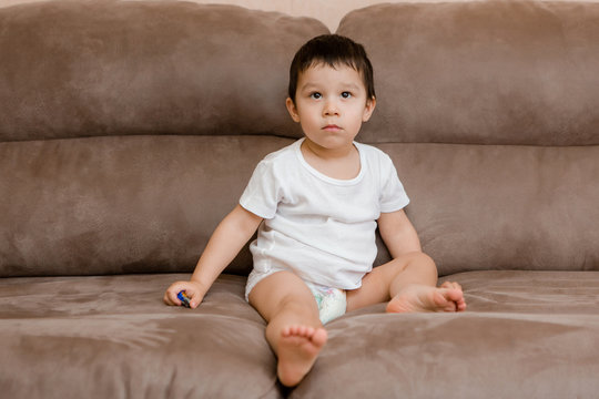 Toddler Boy Brunette Plays At Home on the Couch