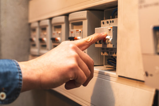 Close-up of the person's hand Repair the switchboard.