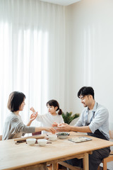 Mom and Dad and daughter at home dumplings