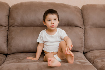 Toddler Boy Brunette Plays At Home on the Couch