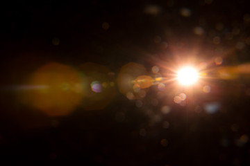 Abstract Natural Sun flare on the black background.