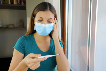 COVID-19 Pandemic Coronavirus Surgical Mask Woman Checking Temperature with Thermometer at Home...