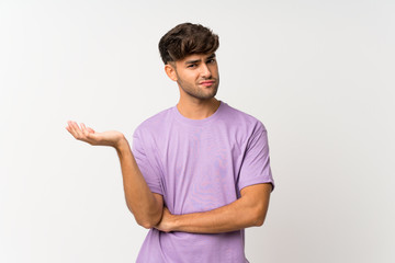 Young handsome man over isolated white background unhappy for not understand something