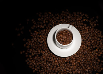 Cup with coffee beans on a dark background