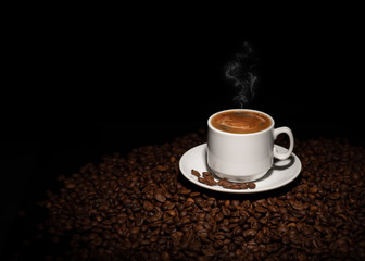 Cup with coffee beans on a dark background