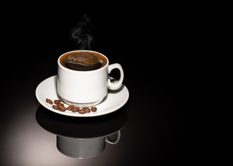 Cup with coffee beans on a dark background