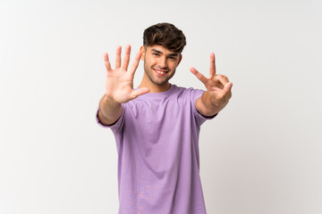 Young handsome man over isolated white background counting seven with fingers