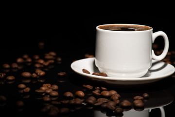 Cup with coffee beans on a dark background