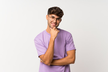 Young handsome man over isolated white background with glasses and smiling