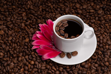 Cup with coffee beans on a dark background