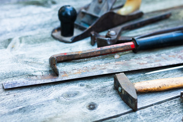 Set of vintage hand construction and carpentry tools hammers on a old wooden background, retro concept .