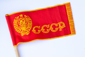 red ussr flag on a stick on an isolated white background since soviet times