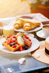 Waffles for breakfast with fresh berries and coffee