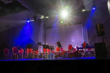 Musical instruments of symphonic orchestra and music stands for music on the concert stage