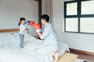 Dad and daughter playing in bed Boxing