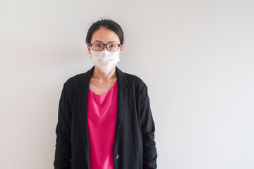 Female Asian young woman wearing surgical mask feeling sick headache and coughing leaning on wall isolated on white background.Wuhan coronavirus (COVID-19) outbreak prevention. Health care concept