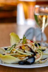 Close up image of sea food with mussels, prawns and salad. Shallow depth of field. Selective focus.