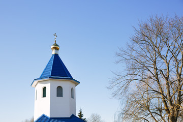 Blue dome of christian church with golden cross. Religious symbol of the Russian Orthodox Church.