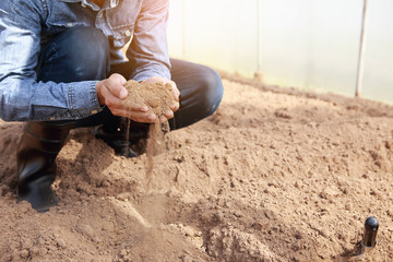 The hand that holds the soil up Concept: Farmers are checking soil conditions before planting.