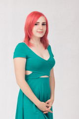 Portrait of a young woman with red hair and green dress with blue eyes