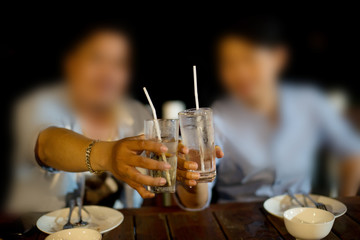 Blurred of happy young people drink whiskey in a restaurant.