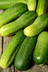 Fresh cucumbers on a wooden table close-up.